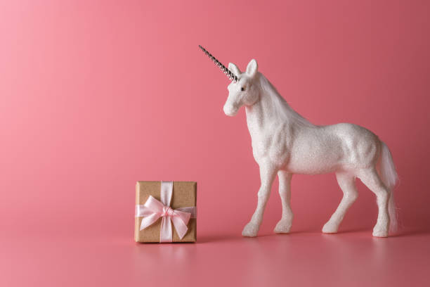 istock Creative composition with glitter unicorn and gift box. Minimal holiday concept. 1183931813