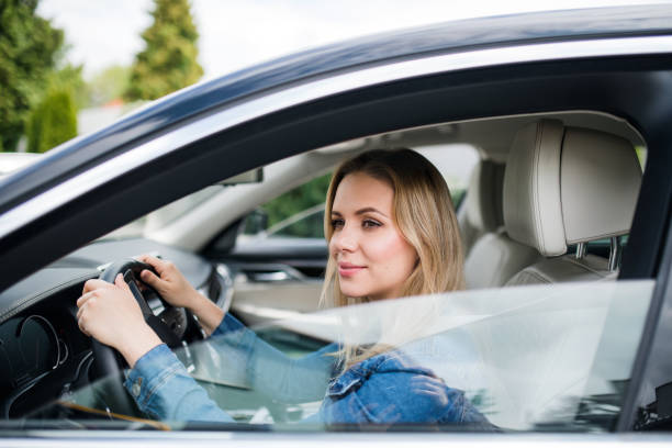 istock Young woman driver sitting in car, waiting. 1183931870