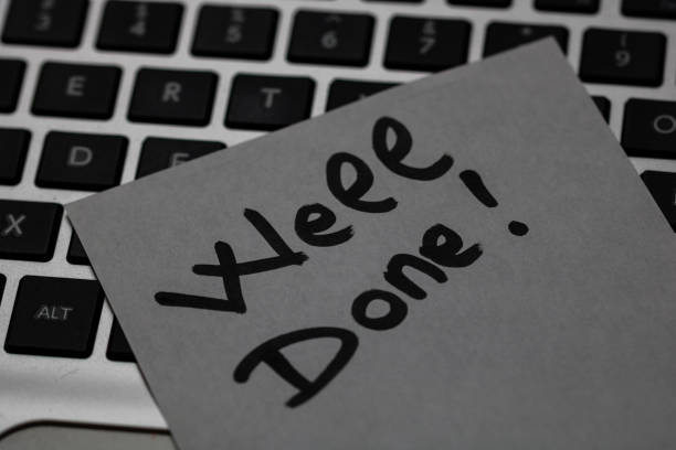 istock Writing on sticky note Well done! Text with Well done! on paper. Sticky note on keyboard. 1183932286