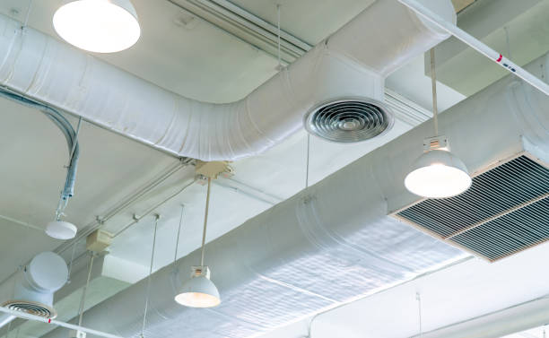 istock Air duct, air conditioner pipe and fire sprinkler system on white ceiling wall. Air flow and ventilation system. Building interior. Ceiling lamp light with opened light. Interior architecture concept. 1183933596