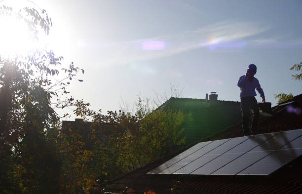 istock Technician installs solar panels on the roof 1183935787