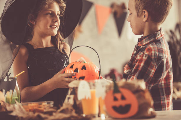 istock Little witch sharing her Halloween candy 1183939350