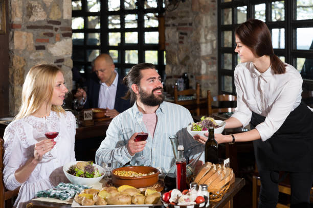 istock Happy people having dinner at rural restaurant and drinking wine 1183939629
