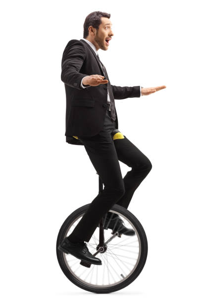 istock Suprised businessman riding a mono-cycle 1183940388