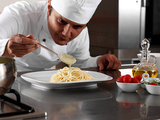 istock Chef Pouring Pesto Sauce 118394300