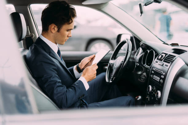 istock Young ceo using touchpad in car stock photo 1183943015