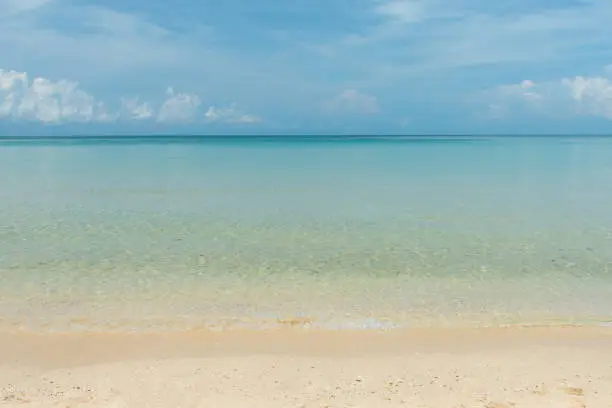 aqua sea water surface waves on white sandy beaches and clouds, natural blue sky. summer vacations at Samed island Rayong Thailand.
