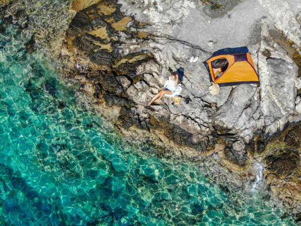 istock Woman camping on the beach. 1183944313
