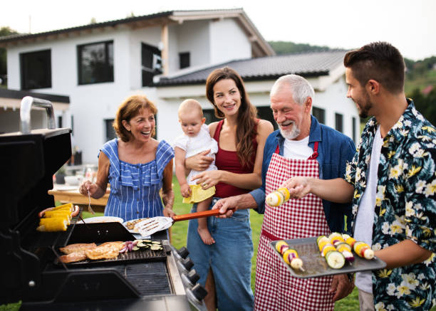 portret wielopokoleniowej rodziny na świeżym powietrzu na grillu ogrodowym, grillowaniu. - barbecue spotkanie towarzyskie zdjęcia i obrazy z banku zdjęć