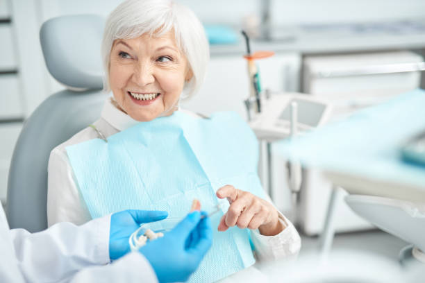 istock Senior lady asking questions about dental dentures 1183945375