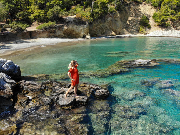 istock Woman looking out to sea from cliffs. 1183945471
