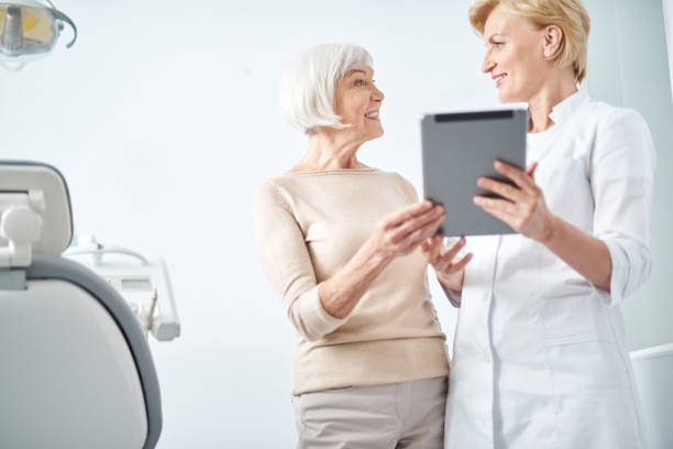 istock Dentist and female patient looking each other 1183945473