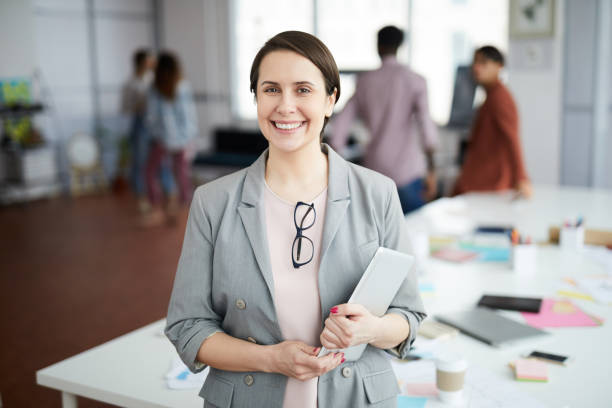 istock Smiling Businesswoman Posing in Office 1183945640