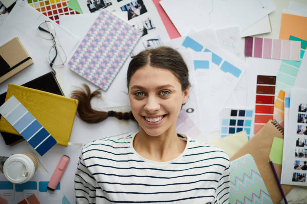 istock Smiling Female Student lying on Floor 1183945698