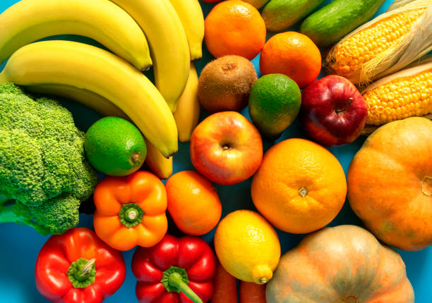 istock Mixed vegetables and fruits on blue background 1183946614