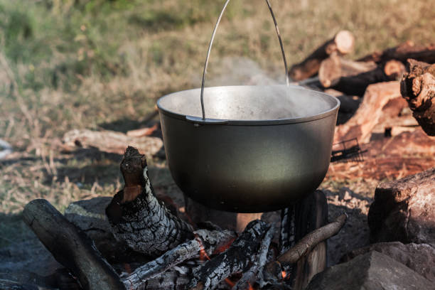 istock Preparing of a soup in used cauldron 1183947409