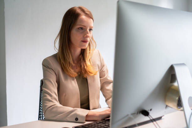 istock Young beautiful woman looking at computer 1183948863