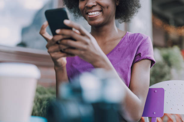istock Close up of woman using mobile phone while sitting 1183951754