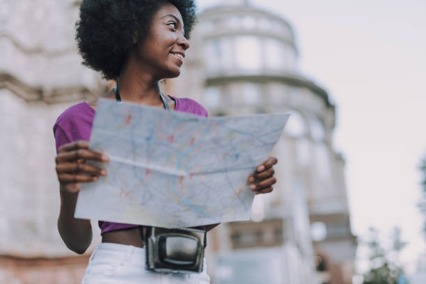 istock Beautiful lady holding a city map in hands 1183951793