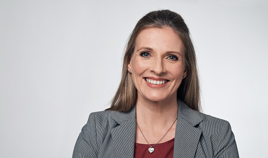 Portrait of a mature businesswoman against a grey background