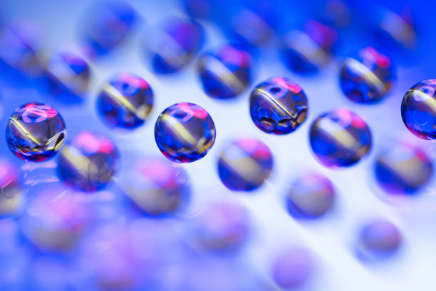 Round capsule round pills, on glass black background.
