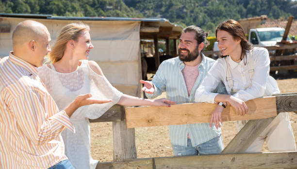 istock Happy friends chatting on rustic farm background 1183953910