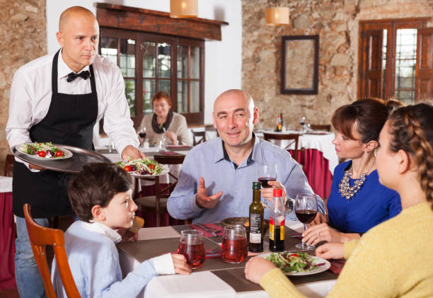 istock Waiter serving dishes to family 1183954018
