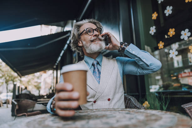 istock Smiling bearded man is talking on mobile phone 1183955987