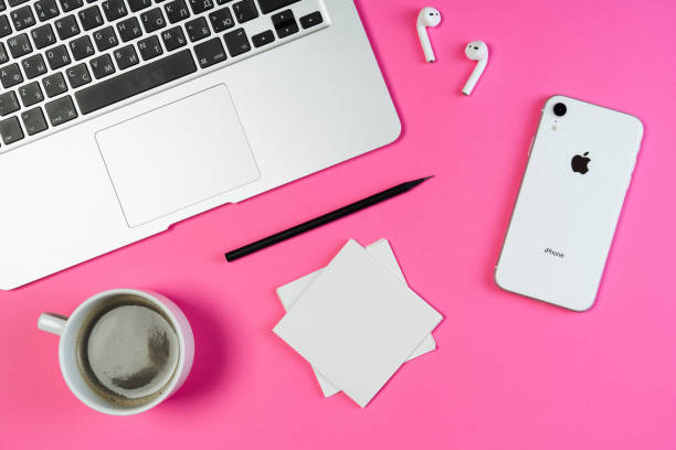 Laptop Phone Coffee Pink Business Workplace KYIV, UKRAINE - FEBRUARY 27 2019: Laptop Phone Coffee Pink Business Workplace Top Flat Lay. White Smartphone, Airpod and Pencil on Minimal Contemporary Background with Paper Note. Freelance Workspace extinction rebellion photos stock pictures, royalty-free photos & images