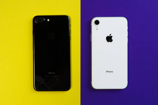 Two Smartphone Yellow Purple Background Flat Lay KYIV, UKRAINE - FEBRUARY 27 2019: iPhone Xr and iPhone 8 Smartphone on Yellow Purple Background Flat Lay. Black and White Mobile Phone Compare Mockup Isolated Above Top View Copy Space Bright Banner iphone 8 stock pictures, royalty-free photos & images