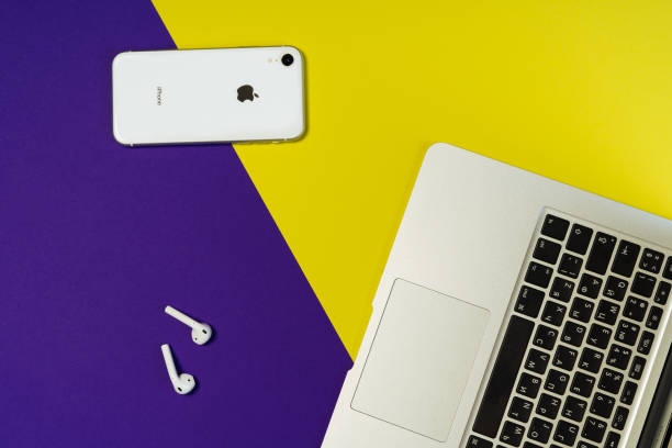 Laptop Phone Earphone Purple Freelance Workspace KYIV, UKRAINE - FEBRUARY 27 2019: Laptop Phone Earphone Purple Freelance Workspace Top Flat Lay. Smartphone and Airpod on Minimal Background. Blank Designer Workplace Inspiration Concept Above Flatlay extinction rebellion photos stock pictures, royalty-free photos & images