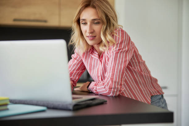 istock Pretty young lady is working at home 1183957886