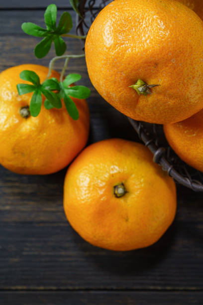 istock Fresh mandarin orange isolated on wooden background 1183957942