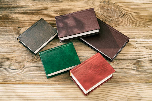 istock Several books on a wooden background, lit by the sun 1183958515