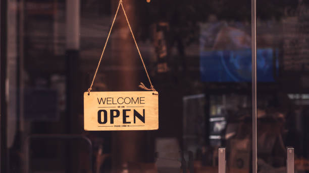 Wooden sign board hanging on door of cafe restaurant Wooden sign board hanging on door of cafe restaurant .Open vintage sign broad through the glass of store window.commercial business background for advertisement restaurant window stock pictures, royalty-free photos & images