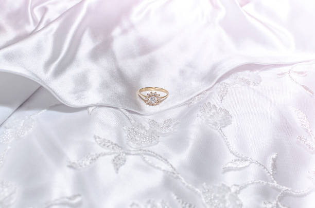 Wedding jewellery on the background of wedding gown material