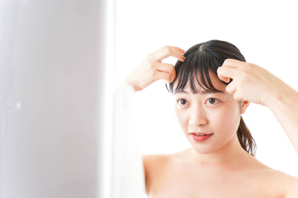 istock Young woman making up at home 1183960583