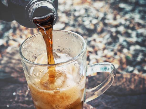 istock Pouring cola drink on glass 1183961490