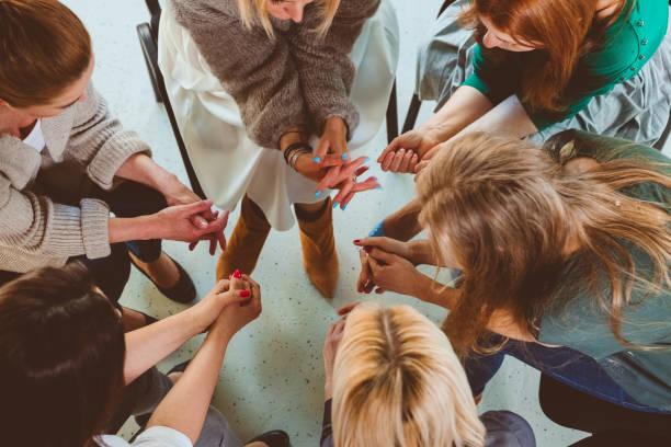 istock Women with hands clasped during therapy session 1183962057