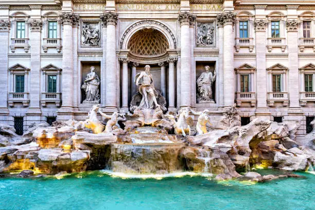 View of beautiful Fontana de Trevi, a monumental fountain in downtown Rome visited by millions of tourists every year.