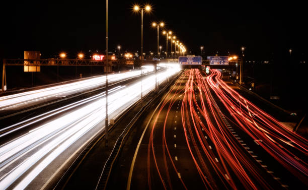 Highway intersection A15/A16 intersection Ridderkerk, Rotterdam Long exposure night capture of traffic at the a15/a16 "Knooppunt Ridderkerk" highway split night freeway stock pictures, royalty-free photos & images