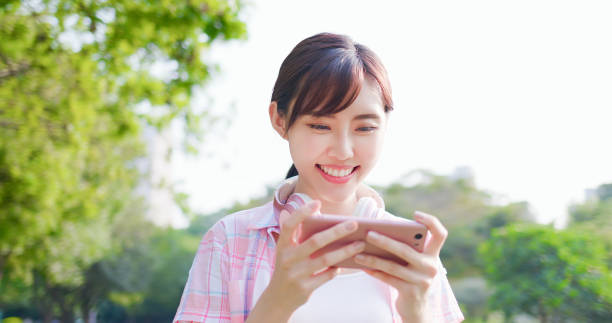 istock girl play game on phone 1183963290