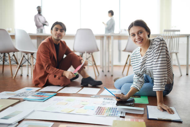 istock Young Busines People Sitting on Floor 1183963433