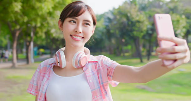 istock young asian woman take selfie 1183963450