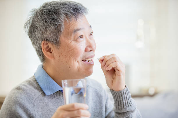 istock old asian man take medicine 1183963510