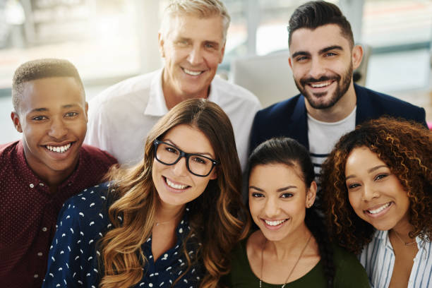 We are destined for greatness Portrait of a group of confident businesspeople standing together in an office colleague photos stock pictures, royalty-free photos & images