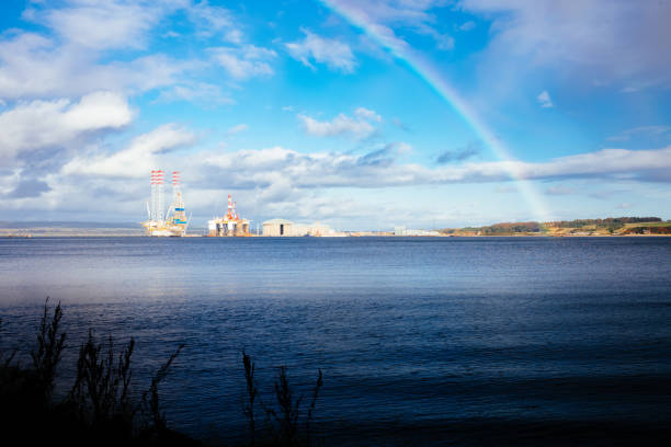 Shoreline beside Cromarty village, Ross and Cromarty, Scotland. Offshore Platforms sit in the Cromarty Firth, used by the oil industry for drilling in the North Sea.