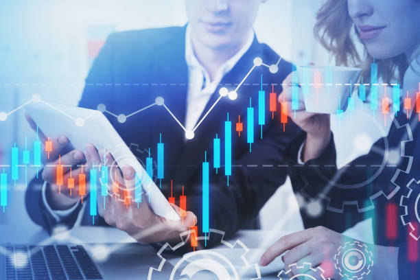istock Man and woman discussing work in office, graph 1183967990