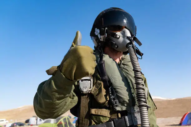 Photo of Pilot with suit and military air. Fighter pilot portrait posing