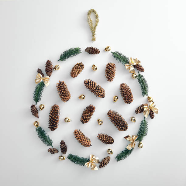 christmas wreath made from tree branch, pine cone and xmas bauble - sillhoutte imagens e fotografias de stock